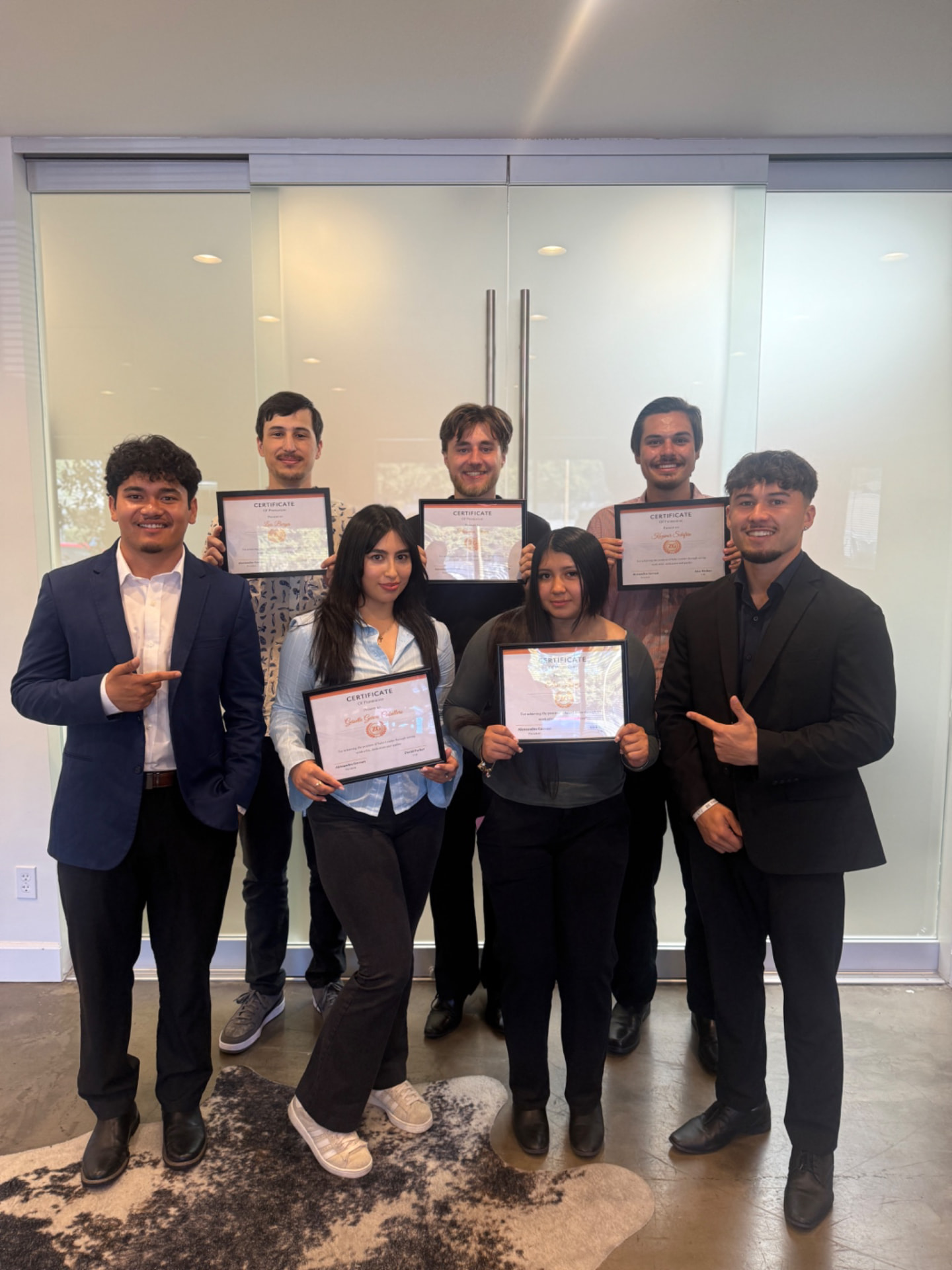 ZG team members with their promotion certificates in the office