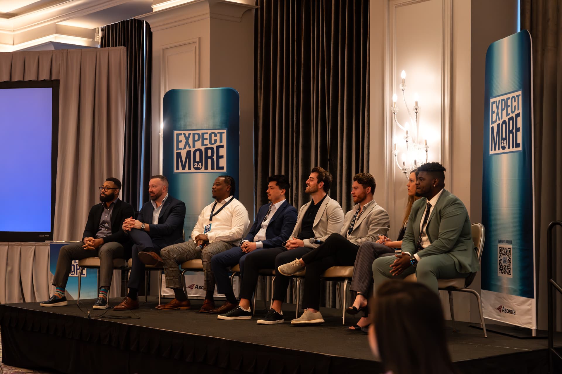 A leadership panel on stage at the Expect More conference