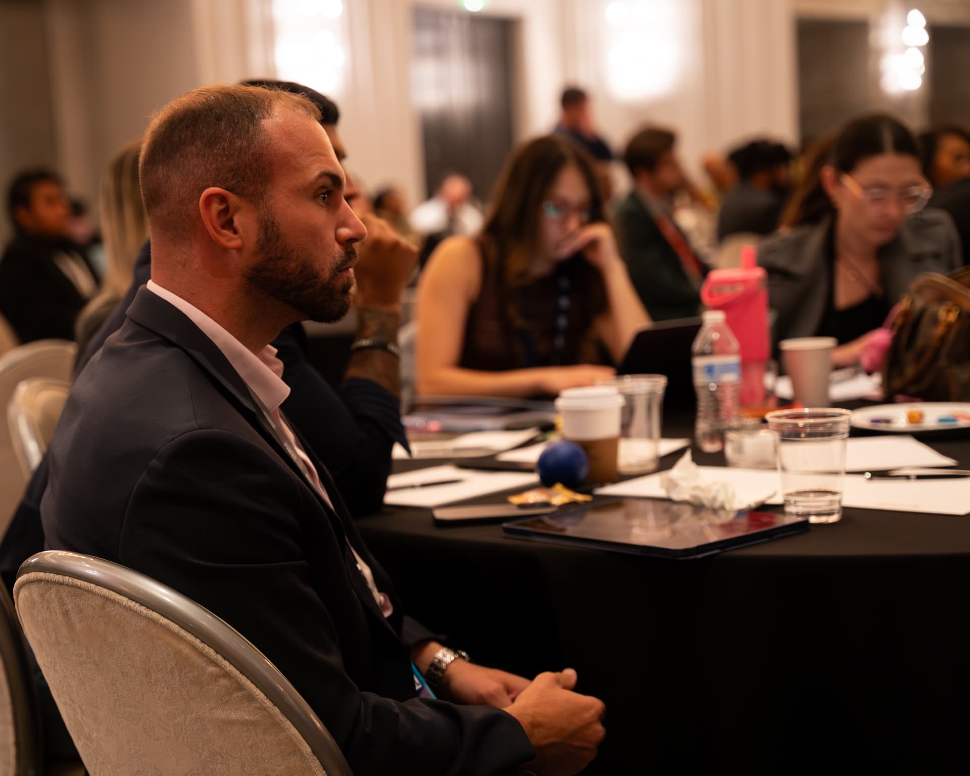 Team members taking notes during a conference session