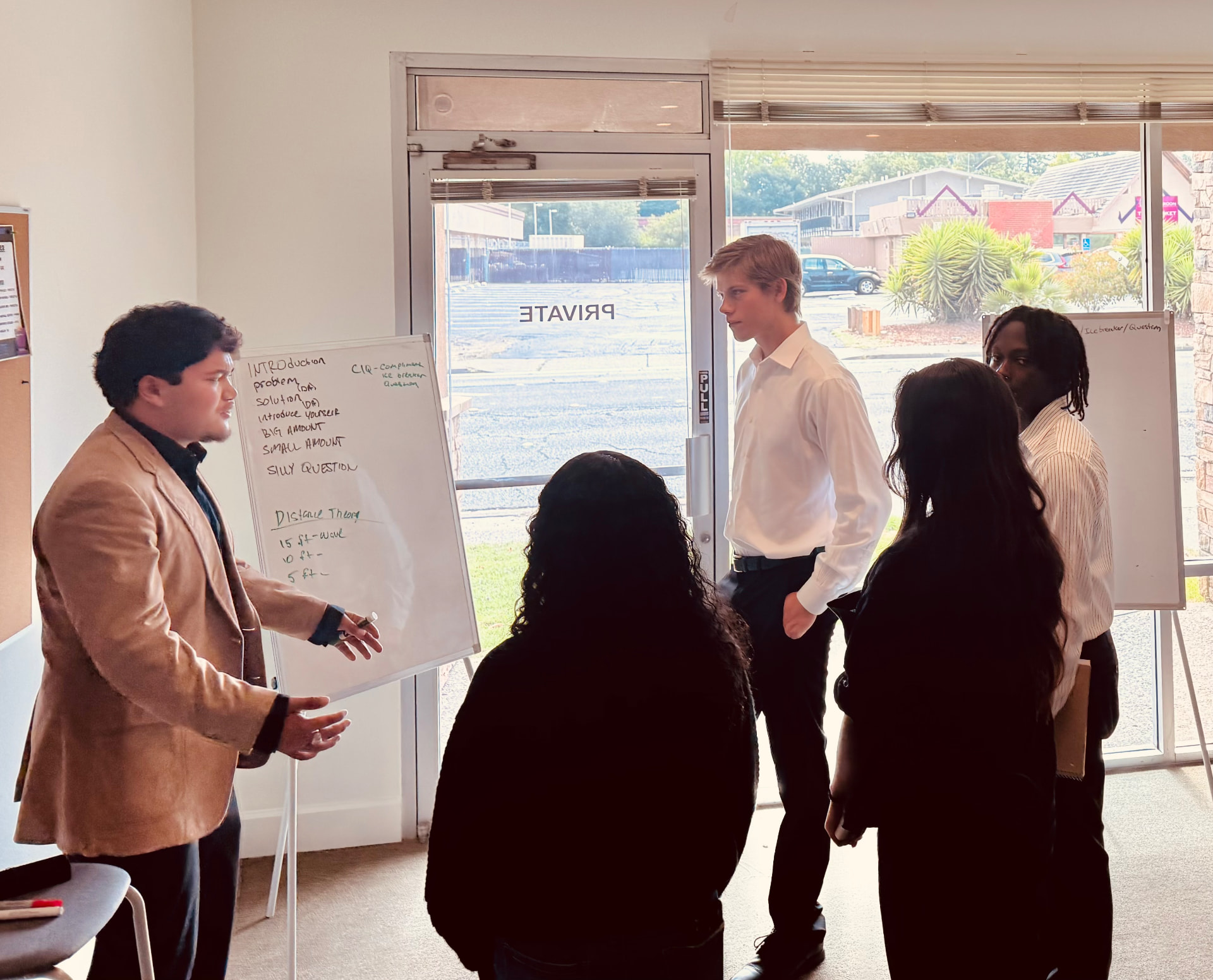 Representatives working through pitch structure at the whiteboard